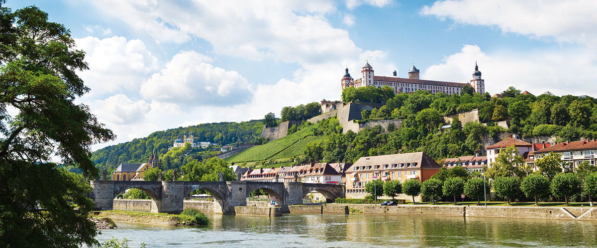 Germany Wurzburg with view over the Main River towards the Alte Mainbruecke and the Festung Marienberg
